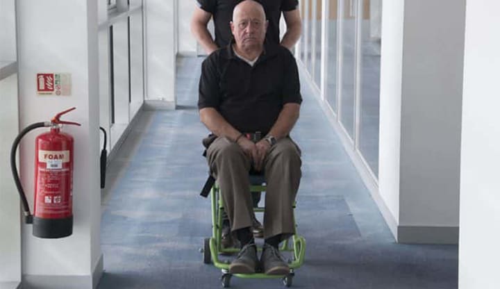 Evacusafe transit chair being used to transfer patient across a level floor